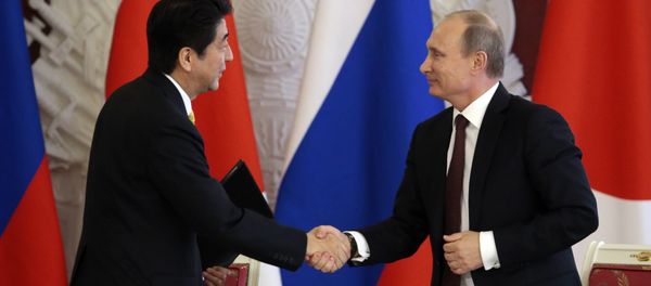 Japanese Prime Minister Shinzo Abe (L) shakes hands with Russian President Vladimir Putin Japanese Prime Minister Shinzo Abe (L) shakes hands with Russian President Vladimir Putin - Sputnik International