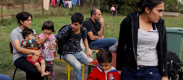 A group of people wait to get accommodation at the entrance of a camp for refugees and migrants in the Belgrade suburb of Krnjaca, Serbia, September 21, 2016. A group of people wait to get accommodation at the entrance of a camp for refugees and migrants in the Belgrade suburb of Krnjaca, Serbia, September 21, 2016. - Sputnik International