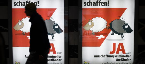 A man walks past backlit posters of the right-wing populist Swiss People's Party (SVP) that translate from German as Finally Create Security to advertise their initiative for the eviction of criminal foreigners in Zurich on February 25, 2016. A man walks past backlit posters of the right-wing populist Swiss People's Party (SVP) that translate from German as Finally Create Security to advertise their initiative for the eviction of criminal foreigners in Zurich on February 25, 2016. - Sputnik International