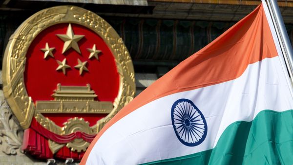 An Indian national flag is flown next to the Chinese national emblem. (File) An Indian national flag is flown next to the Chinese national emblem. (File) - Sputnik International