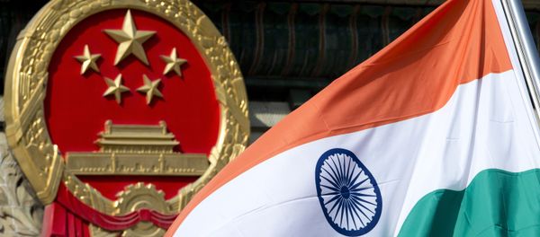 An Indian national flag is flown next to the Chinese national emblem. (File) - Sputnik International