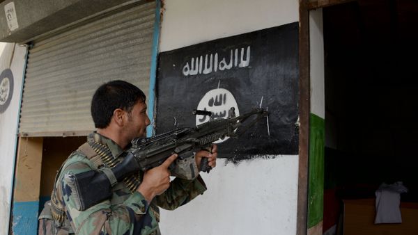 An Afghan soldier points his gun at Daesh militants group banner as he patrols during ongoing clashes in Kot District in eastern Nangarhar province An Afghan soldier points his gun at Daesh militants group banner as he patrols during ongoing clashes in Kot District in eastern Nangarhar province - Sputnik International