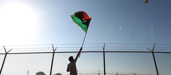 A man waves a Libyan flag A man waves a Libyan flag - Sputnik International