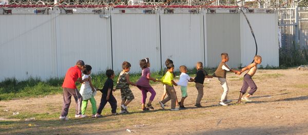 Boarders in Hungary stand tall as children play and attempt to try and live a normal life in the camp. Boarders in Hungary stand tall as children play and attempt to try and live a normal life in the camp. - Sputnik International