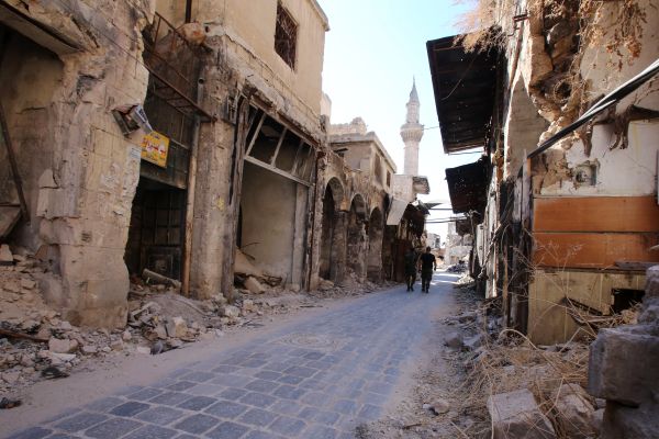 Syrian government soldiers walk in the damaged al-Farafira souk in the government-held side of Aleppo's historic city centre on September 16, 2016 - Sputnik International