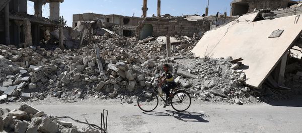 A Syrian boy rides a bicycle past destroyed buildings in the rebel-held town of Douma, on the eastern outskirts of the capital Damascus on September 25, 2016 A Syrian boy rides a bicycle past destroyed buildings in the rebel-held town of Douma, on the eastern outskirts of the capital Damascus on September 25, 2016 - Sputnik International
