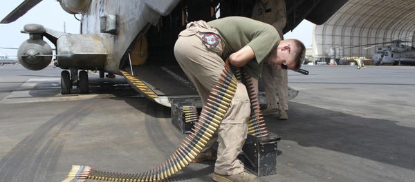 In this photo taken May 26, 2010, Sgt. Tyler Johnson, 23, of Portland, Ore., loads ammunition cans for a .50 caliber machine gun mounted on the back of a Marine CH53 at Camp Lemonnier, Djibouti, the only U.S. base in Africa - Sputnik International