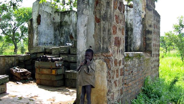 A Sudanese child is pictured in front of a partially-destroyed house used to store ammunitions in Yei, south Sudan, where the Sudan People's Liberation Army has its headquarters (File) A Sudanese child is pictured in front of a partially-destroyed house used to store ammunitions in Yei, south Sudan, where the Sudan People's Liberation Army has its headquarters (File) - Sputnik International