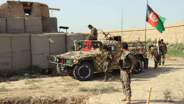 Afghan National Army (ANA) soldiers stand next to an outpost where 12 soldiers were killed by their comrades in the northern city of Kunduz, Afghanistan September 27, 2016 - Sputnik International
