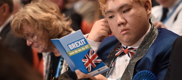 A delegate reads a leaflet entitled BREXIT, how do we do it? as he sits in the audience on the second day of the annual Conservative Party conference at the International Convention Centre in Birmingham, central England, on October 3, 2016. - Sputnik International