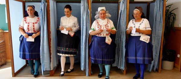 Hungarian women wearing traditional costume leave a voting booth at a polling station during a referendum on EU migrant quotas in Veresegyhaz, Hungary, October 2, 2016. - Sputnik International
