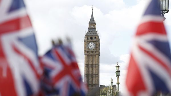 Union flags on sale at a souvenir stall fly in the breeze opposite the Houses of Parliament in London, Britain - Sputnik International