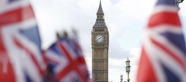Union flags on sale at a souvenir stall fly in the breeze opposite the Houses of Parliament in London, Britain - Sputnik International