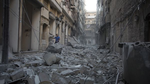 A Syrian man stands in the rubble of destroyed buildings following an air strike in Aleppo's rebel-controlled neighbourhood of Karm al-Jabal. (File) A Syrian man stands in the rubble of destroyed buildings following an air strike in Aleppo's rebel-controlled neighbourhood of Karm al-Jabal. (File) - Sputnik International