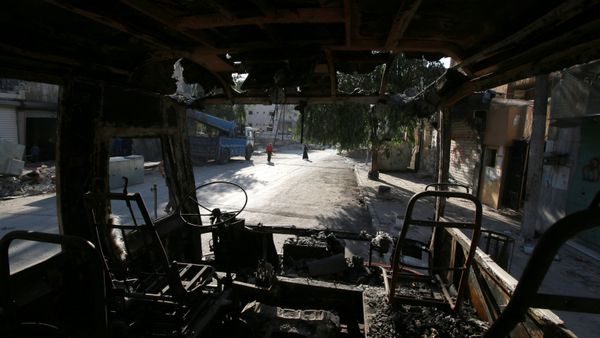 People walk past a burnt bus in the rebel held Seif al-Dawla neighbourhood of Aleppo, Syria October 6, 2016 People walk past a burnt bus in the rebel held Seif al-Dawla neighbourhood of Aleppo, Syria October 6, 2016 - Sputnik International