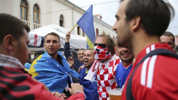 Kosovo and Croatia's fans draped in national flags sing together ahead of the World Cup Group I qualifying match between Kosovo and Croatia in main square in Shkoder, Albania on Thursday Oct. 6, 2016 - Sputnik International