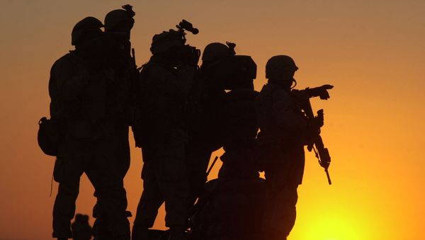 U.S. Marines scan the northwest perimeter of the American military compound at Afghanistan's Kandahar airport using sophisticated thermal imagery equipment, while Marines in light armored vehicles, supported by U.S. special forces and helicopters, search houses outside the perimeter of the airfield, Monday Jan. 14, 2002 - Sputnik International