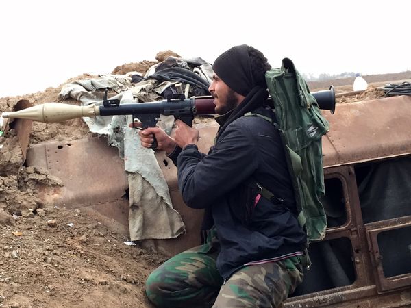 A supporter of the Syrian government holds a position in the northeastern Syrian city of Deir ez-Zor. File photo  - Sputnik International