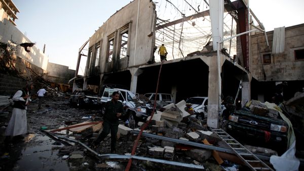 People stand at the site of an airstrike which witnesses said was by Saudi-led coalition aircraft on mourners at a hall where a wake for the father of Jalal al-Roweishan, the interior minister in the Houthi-dominated Yemeni government, was being held, in Sanaa, Yemen October 8, 2016 People stand at the site of an airstrike which witnesses said was by Saudi-led coalition aircraft on mourners at a hall where a wake for the father of Jalal al-Roweishan, the interior minister in the Houthi-dominated Yemeni government, was being held, in Sanaa, Yemen October 8, 2016 - Sputnik International