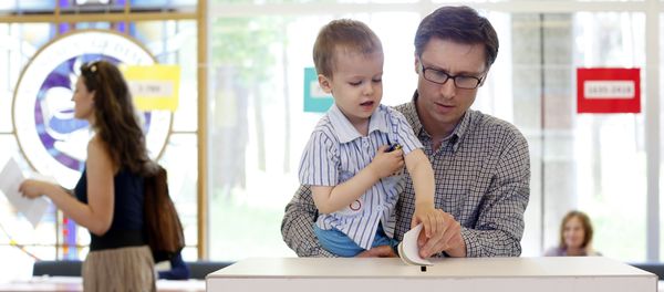 A man with a child casts his ballot during the elections in Vilnius, Lithuania (File) A man with a child casts his ballot during the elections in Vilnius, Lithuania (File) - Sputnik International