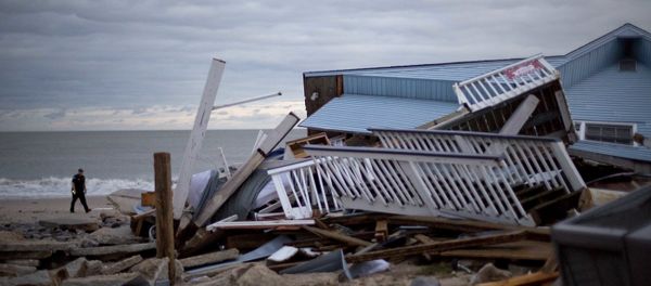 A police officer walks past the remnants of a home leveled by Hurricane Matthew after it hit the tiny beach community of Edisto Beach, S.C., Saturday, Oct. 8, 2016. A police officer walks past the remnants of a home leveled by Hurricane Matthew after it hit the tiny beach community of Edisto Beach, S.C., Saturday, Oct. 8, 2016. - Sputnik International