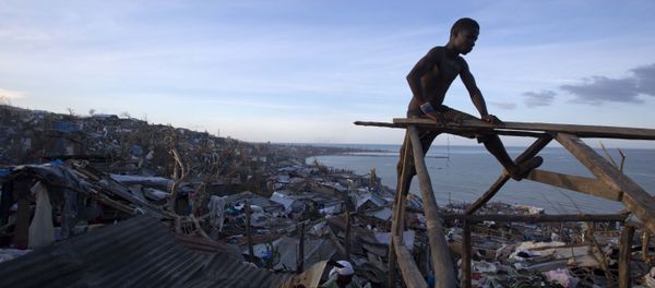 A resident works to repair his roof after it was ripped away by Hurricane Matthew in Jeremie, Haiti, Friday, Oct. 7, 2016 - Sputnik International