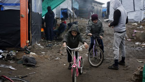 Afghan children ride their bicycles in a makeshift migrants camp near Calais, France, Thursday Feb. 25, 2016 Afghan children ride their bicycles in a makeshift migrants camp near Calais, France, Thursday Feb. 25, 2016 - Sputnik International