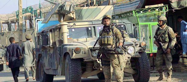Afghan security forces keep watch in front of their armoured vehicle in Kunduz city, Afghanistan October 4, 2016 - Sputnik International