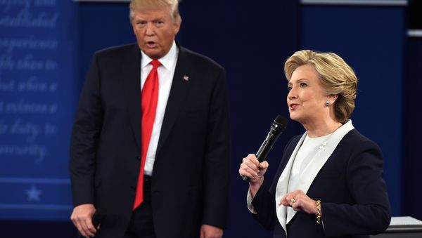 US Democratic presidential candidate Hillary Clinton and US Republican presidential candidate Donald Trump debate during the second presidential debate at Washington University in St. Louis, Missouri, on October 9, 2016 - Sputnik International