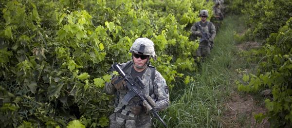 U.S. Army soldiers from the 1-320th Alpha Battery, 2nd Brigade of the 101st Airborne Division, walk among grape orchards during a patrol towards COP Nolen, in the volatile Arghandab Valley, Kandahar, Afghanistan, Tuesday, July 20, 2010 - Sputnik International