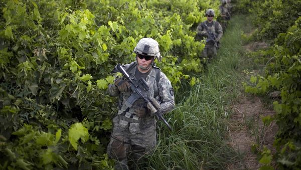 U.S. Army soldiers from the 1-320th Alpha Battery, 2nd Brigade of the 101st Airborne Division, walk among grape orchards during a patrol towards COP Nolen, in the volatile Arghandab Valley, Kandahar, Afghanistan, Tuesday, July 20, 2010 U.S. Army soldiers from the 1-320th Alpha Battery, 2nd Brigade of the 101st Airborne Division, walk among grape orchards during a patrol towards COP Nolen, in the volatile Arghandab Valley, Kandahar, Afghanistan, Tuesday, July 20, 2010 - Sputnik International