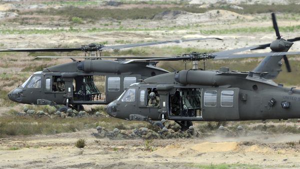 U.S. Army Black Hawk helicopters support soldiers during the NATO Noble Jump exercise on a training range near Swietoszow Zagan, Poland. Polish leaders say the country is buying Polish-made Black Hawk helicopters as it modernizes the army. - Sputnik International