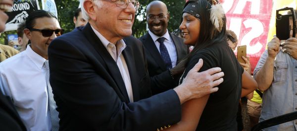Sen. Bernie Sanders, I-Vt., left, greets Jasilyn Charger, a member of the Cheyenne River Sioux Tribal Youth Council, after Charger spoke to a group of supporters of the Standing Rock Sioux Tribe who were rallying in opposition of the Dakota Access oil pipeline, during a rally by the White House, Tuesday, Sept. 13, 2016, in Washington. Sanders also spoke at the rally. Sen. Bernie Sanders, I-Vt., left, greets Jasilyn Charger, a member of the Cheyenne River Sioux Tribal Youth Council, after Charger spoke to a group of supporters of the Standing Rock Sioux Tribe who were rallying in opposition of the Dakota Access oil pipeline, during a rally by the White House, Tuesday, Sept. 13, 2016, in Washington. Sanders also spoke at the rally. - Sputnik International