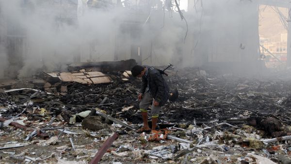 A Yemeni inspects the rubble of a destroyed building following an air strike on a funeral ceremony in the capital Sanaa on October 8, 2016 - Sputnik International