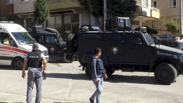 Ambulances and security members attend the scene, near an explosion site after suicide bombers blew themselves up Sunday during a police raid against suspected Islamic State militants near the Syrian border, in Gaziantep, Turkey, Sunday, Oct. 16, 2016 - Sputnik International