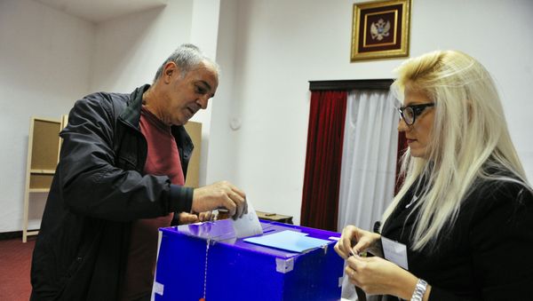 A man casts his ballot during parliamentary elections at a polling station in Podgorica on October 16, 2016. Montenegro began voting in parliamentary elections on October 16, 2016 with opposition groups hoping to end the quarter-century rule of pro-Western premier Milo Djukanovic, who warns that his rivals would derail imminent NATO accession. - Sputnik International