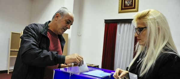 A man casts his ballot during parliamentary elections at a polling station in Podgorica on October 16, 2016. Montenegro began voting in parliamentary elections on October 16, 2016 with opposition groups hoping to end the quarter-century rule of pro-Western premier Milo Djukanovic, who warns that his rivals would derail imminent NATO accession. A man casts his ballot during parliamentary elections at a polling station in Podgorica on October 16, 2016. Montenegro began voting in parliamentary elections on October 16, 2016 with opposition groups hoping to end the quarter-century rule of pro-Western premier Milo Djukanovic, who warns that his rivals would derail imminent NATO accession. - Sputnik International