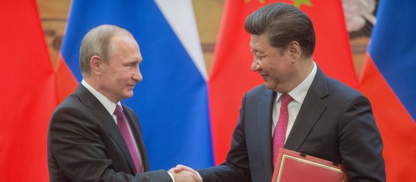 Russian President Vladimir Putin, left, and President of the People's Republic of China Xi Jinping during a signing ceremony of documents following their talks in Beijing Russian President Vladimir Putin, left, and President of the People's Republic of China Xi Jinping during a signing ceremony of documents following their talks in Beijing - Sputnik International