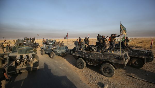 Iraqi forces deploy in the area of al-Shourah, some 45 kms south of Mosul, as they advance towards the city to retake it from the Islamic State (IS) group jihadists, on October 17, 2016. Iraqi Prime Minister Haider al-Abadi announced earlier in the day that the long-awaited operation to recapture Mosul was under way Iraqi forces deploy in the area of al-Shourah, some 45 kms south of Mosul, as they advance towards the city to retake it from the Islamic State (IS) group jihadists, on October 17, 2016. Iraqi Prime Minister Haider al-Abadi announced earlier in the day that the long-awaited operation to recapture Mosul was under way - Sputnik International