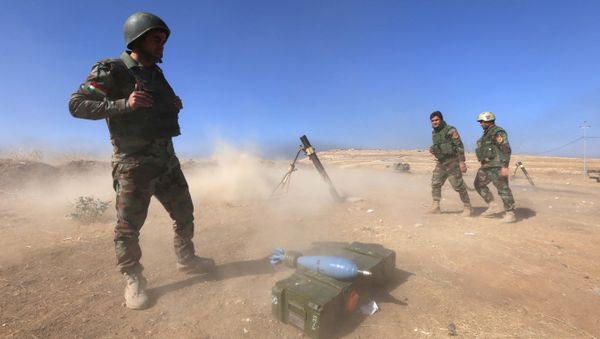 Iraqi Kurdish Peshmerga fighters fire a mortar shell from the top of Mount Zardak, about 25 kilometres east of Mosul, as they take part in an operation against Islamic State (IS) group jihadists, on October 17, 2016 - Sputnik International