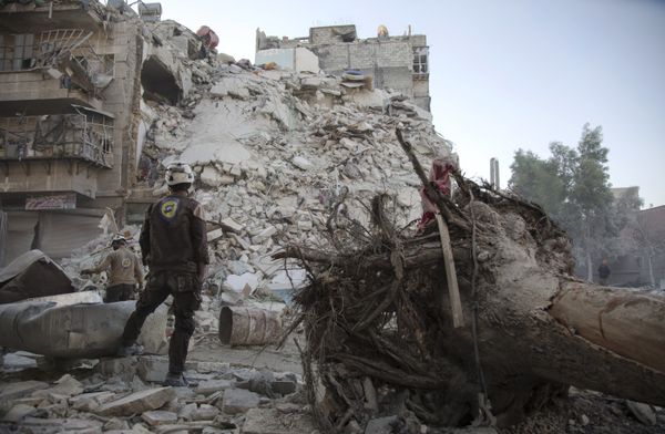 A member of the Syrian Civil Defence, known as the White Helmets, stands amid the rubble of a destroyed building during a rescue operation following reported air strikes in the rebel-held Qatarji neighbourhood of the northern city of Aleppo, on October 17, 2016 A member of the Syrian Civil Defence, known as the White Helmets, stands amid the rubble of a destroyed building during a rescue operation following reported air strikes in the rebel-held Qatarji neighbourhood of the northern city of Aleppo, on October 17, 2016 - Sputnik International