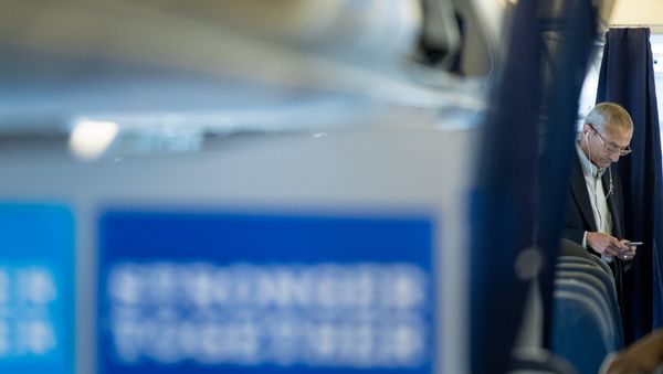 Clinton campaign manager John Podesta looks at a smartphone while aboard a plane at Westchester County Airport in White Plains, N.Y., Tuesday, Oct. 11, 2016, before traveling to Miami - Sputnik International