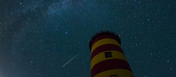 A falling star crosses the night sky behind the lighthouse in Pilsum, northwestern Germany A falling star crosses the night sky behind the lighthouse in Pilsum, northwestern Germany - Sputnik International