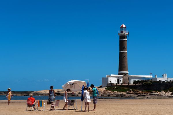 Tourists enjoy the beach near the lighthouse of Jose Ignacio, next to Punta del Este, one of the most exclusive seaside resorts of Latin America, 140 kilometers east from Montevideo, on January 13, 2012. Tourists enjoy the beach near the lighthouse of Jose Ignacio, next to Punta del Este, one of the most exclusive seaside resorts of Latin America, 140 kilometers east from Montevideo, on January 13, 2012. - Sputnik International