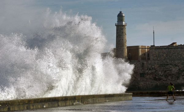 A youngster (R) stands in front of a huge wave breaking in Havana's seafront. A youngster (R) stands in front of a huge wave breaking in Havana's seafront. - Sputnik International