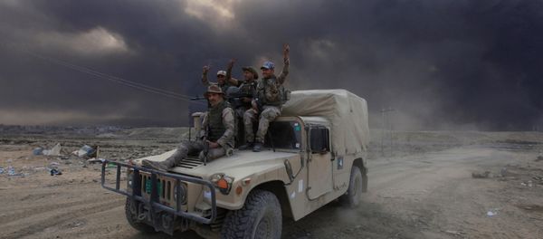 Iraqi army personnel ride on a military vehicle in Qayyarah, during an operation to attack Islamic State militants in Mosul, Iraq Iraqi army personnel ride on a military vehicle in Qayyarah, during an operation to attack Islamic State militants in Mosul, Iraq - Sputnik International