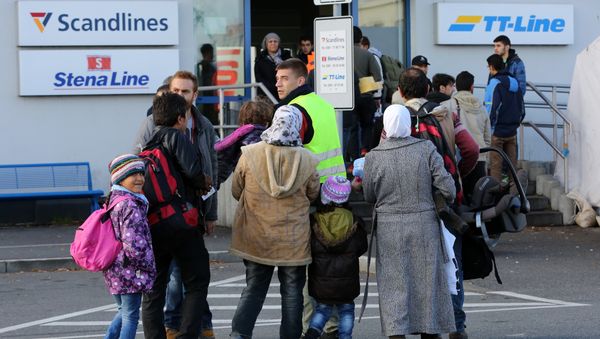 Migrants go to the ferry terminal to buy tickets at the port of Rostock, northeastern Germany - Sputnik International
