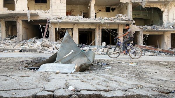 A man rides a bicycle near damaged ground in the rebel held besieged al-Sukkari neighbourhood of Aleppo, Syria October 19, 2016. A man rides a bicycle near damaged ground in the rebel held besieged al-Sukkari neighbourhood of Aleppo, Syria October 19, 2016. - Sputnik International