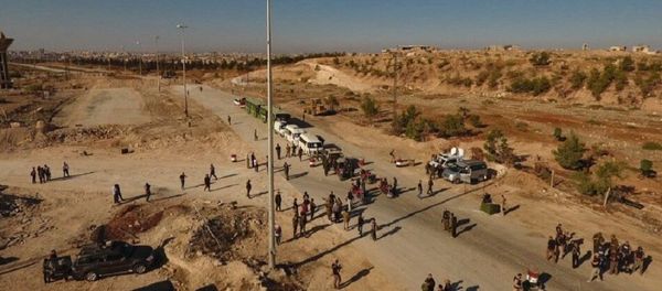 Law enforcement officers near cars and ambulances in a humanitarian corridor for civilians and militants along the Castello Road in northern Aleppo, Syria - Sputnik International