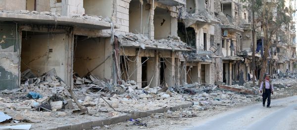 A man walks past damaged buildings in the rebel held besieged al-Sukkari neighbourhood of Aleppo, Syria October 19, 2016. A man walks past damaged buildings in the rebel held besieged al-Sukkari neighbourhood of Aleppo, Syria October 19, 2016. - Sputnik International